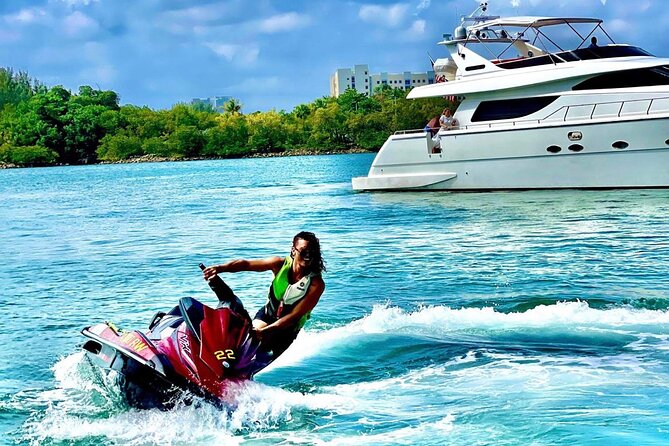 Rows of yellow jet skis securely tied to a crowded wooden dock in a Miami Beach marina under bright morning sunlight